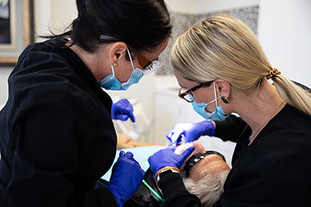 Doctors operating on a patient at Reich Dental Center in Smyrna and Roswell, GA