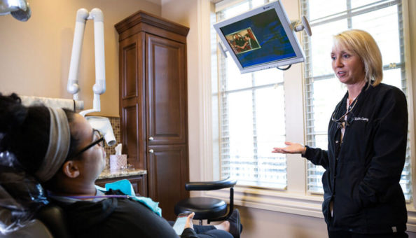Dr.Kristin explains to patient at Reich Dental Center